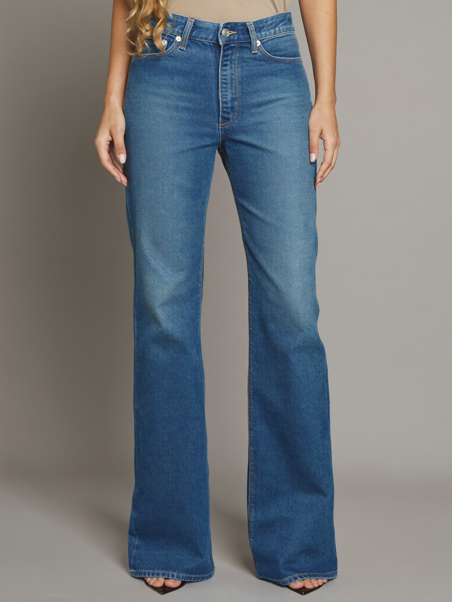 Blonde curly-haired model wearing Women's Blue Denim Jeans