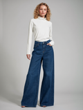 Blonde curly-haired model wearing High-Rise Wide-Leg Jeans in Midnight Blue