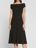 Model wearing black boatneck ponte midi dress with pockets