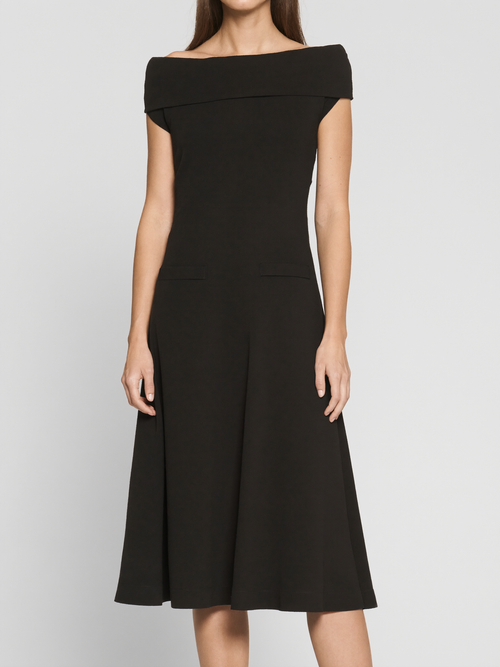 Model wearing black boatneck ponte midi dress with pockets