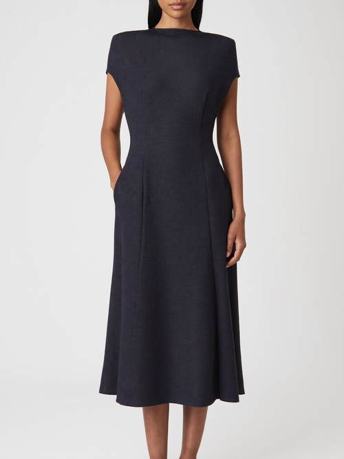 Model wearing midnight navy boatneck ponte midi dress with pockets