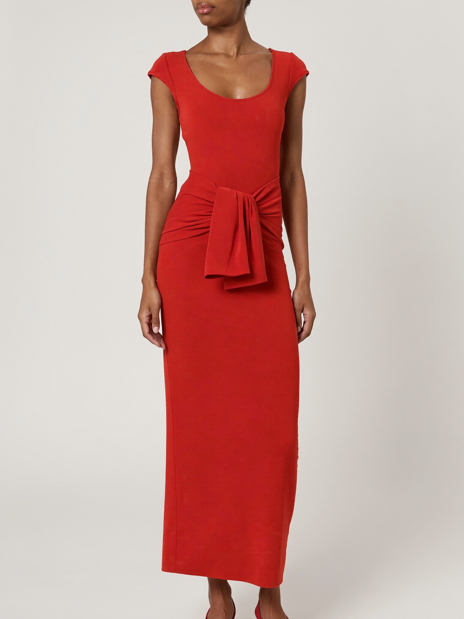 Model wearing red bodycon twist-waist cocktail dress