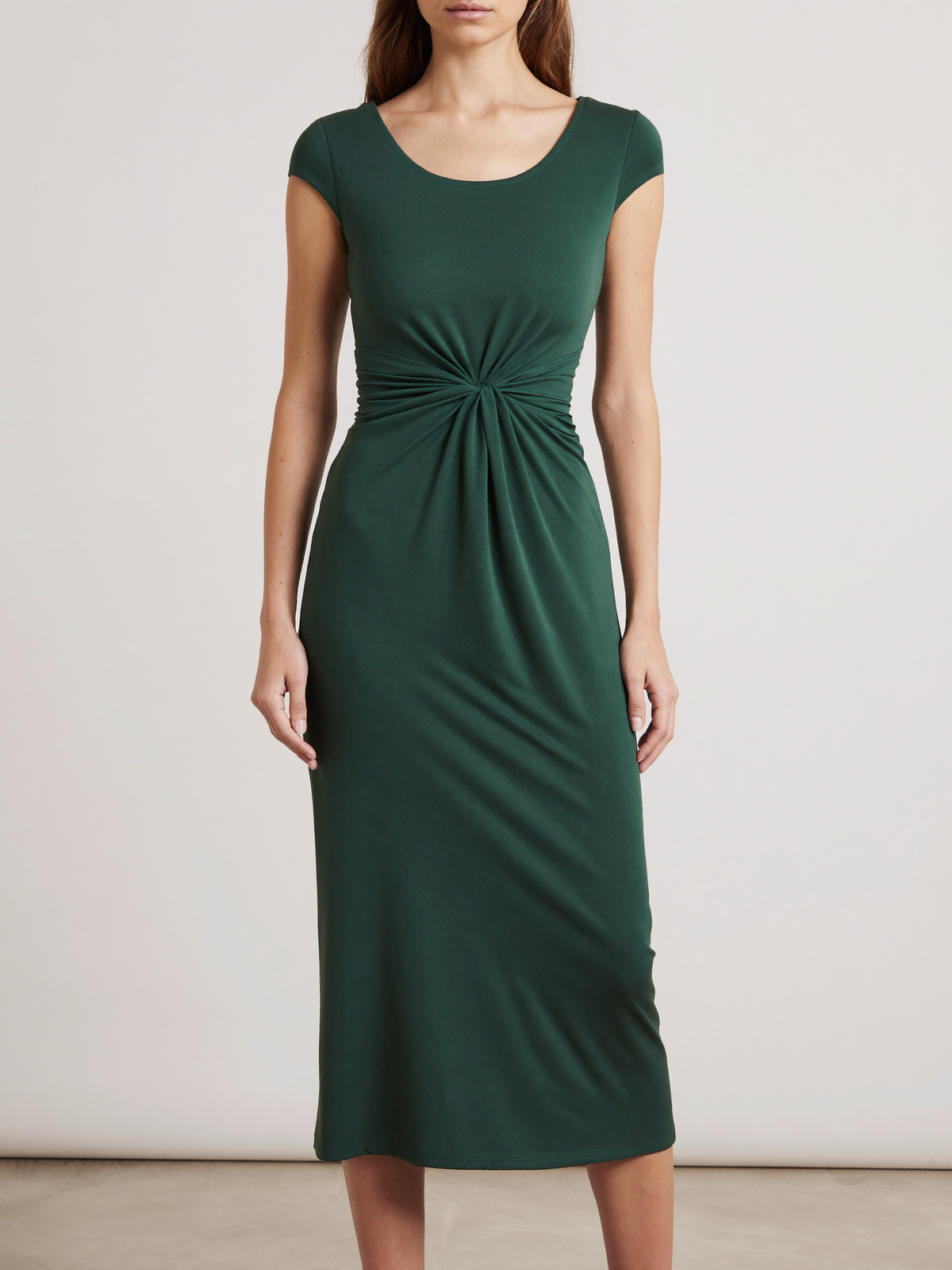 Model wearing dark green bodycon twist-waist cocktail dress