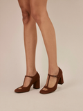 Model wearing brown Mary Jane block heel pumps