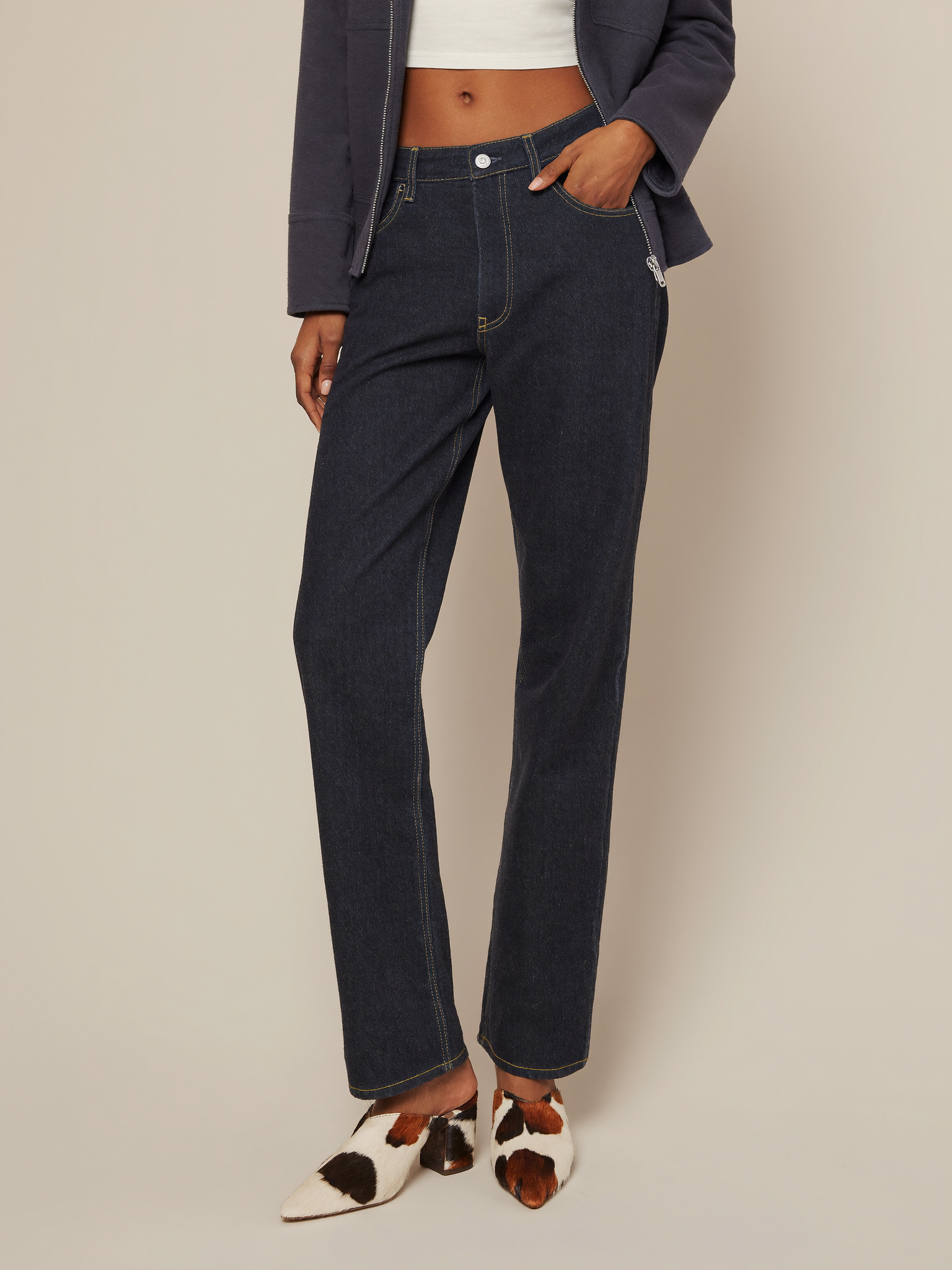 Full body model wearing cow print calf hair loafer mules